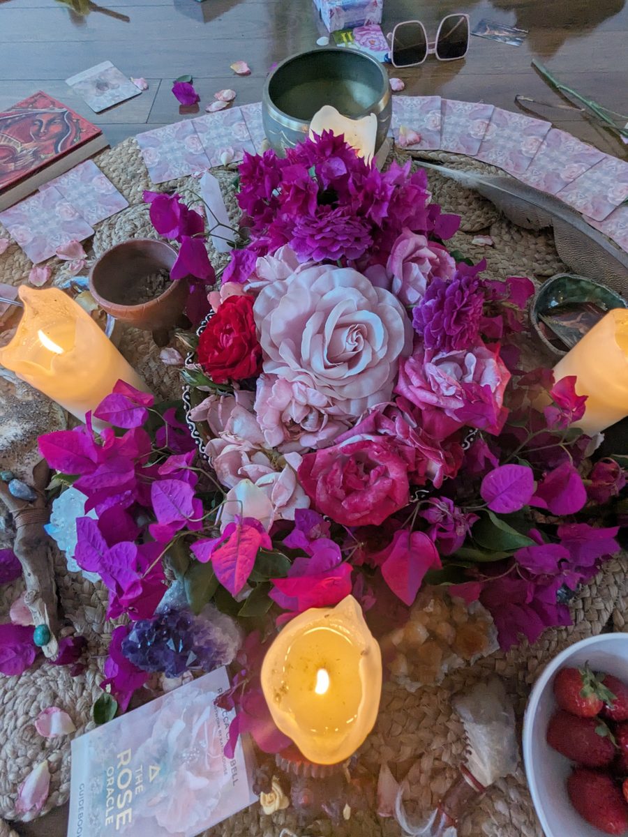 Rose and bougainvillea flower altar with candles, set for a Mystic Rose women's ceremony in Fremantle